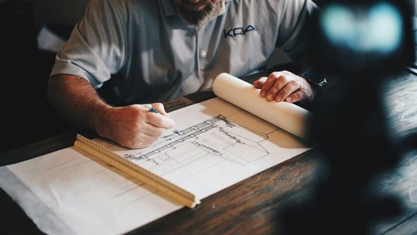 Building plans being marked up on a table