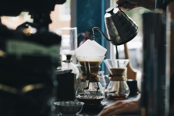 A barista pouring filter coffee