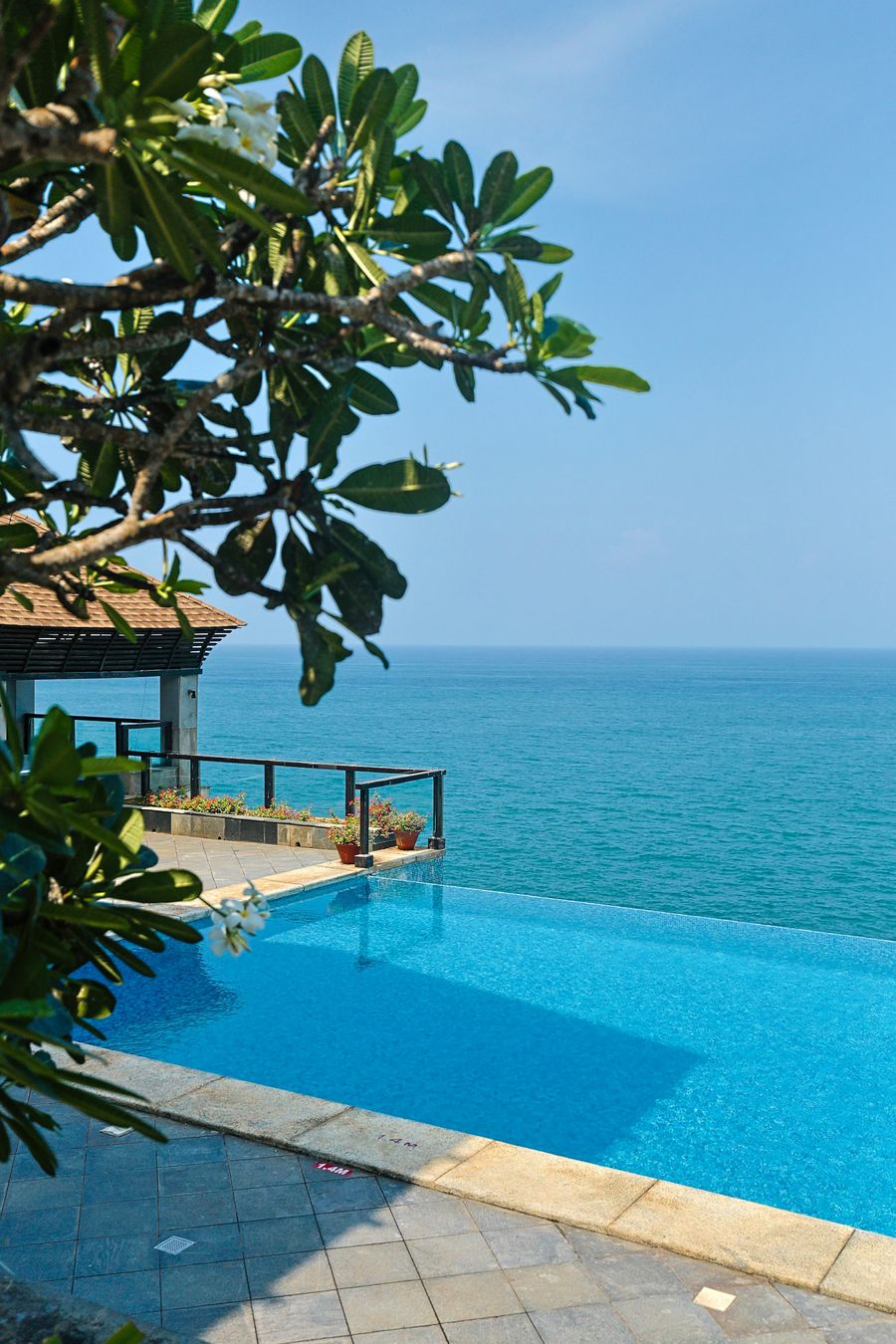 The pool edge dissolving into open sea.